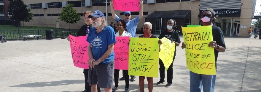 DRACO members, NAN members, and Sacred Heart Minister Eric Blount Demanding acountability in the DPD. Literacy activist John Telford in front.