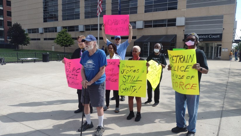 DRACO members, NAN members, and Sacred Heart Minister Eric Blount Demanding acountability in the DPD. Literacy activist John Telford in front.