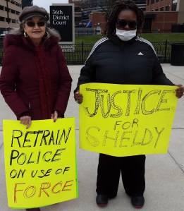 Kathy Montgomery (left) and Kinda McKinney-Anderson (Right) hold vigil outside courthouse on April 4, 2023.